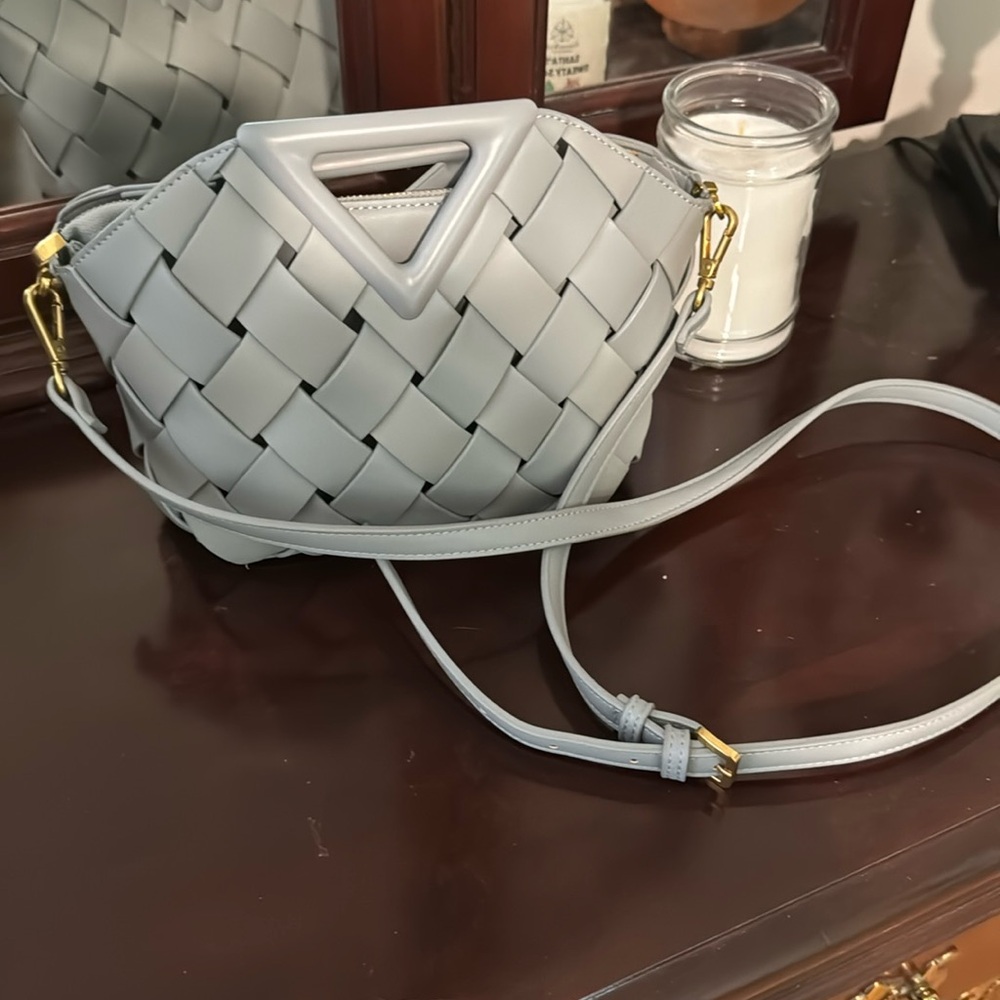 Mellie Bianco began leather light gray purse. Inside comes out. Used one time.